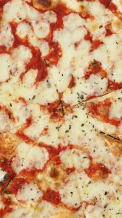 Top View of Pizza with Tomatoes and Cheese Rotate in Circle Pizzeria