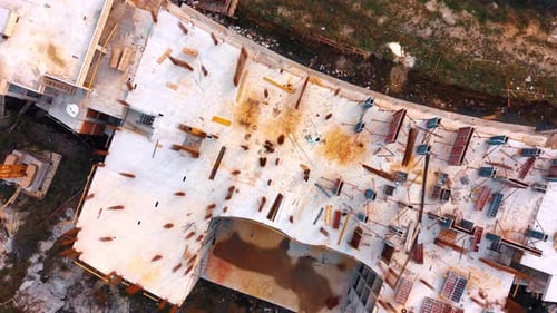 Circling and descending over the top of the structure under construction.
