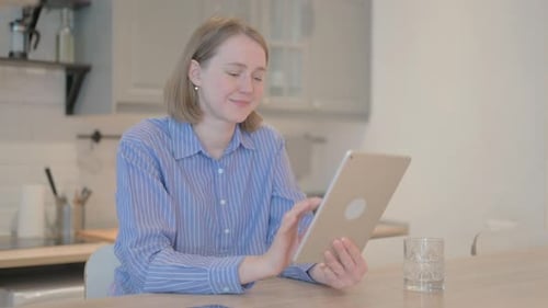 Woman Uses Tablet Device in Home Setting