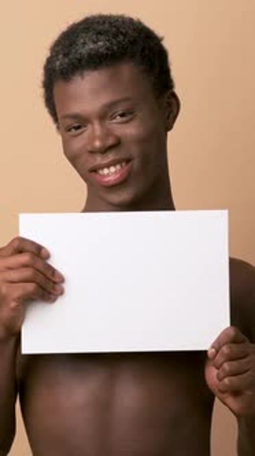 Smiling Young Adult Holding a Blank White Sign