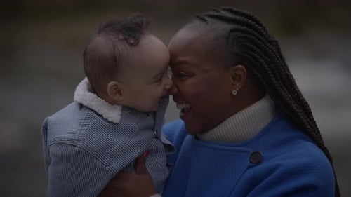 Mother Holding Young Baby Child Boy Outside Enjoying Family Life