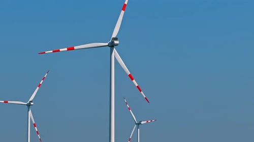 Wind Turbines Rotating in a Clear Blue Sky