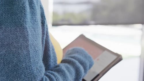 Person Uses Tablet with Smart Home Automation App