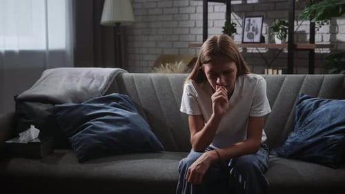 Woman on Couch Contemplating Her Thoughts in Living Room