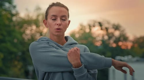 Active Healthy Sportswoman Training in City Park Stretching Shoulder Muscles Warm Up Gymnastic