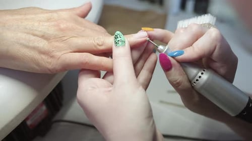 Manicurist Filing Nails in a Beauty Salon