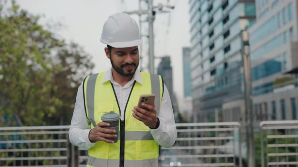 Portrait of Male Taskmaster with Coffee Cup Reading in Phone on Bridge ...