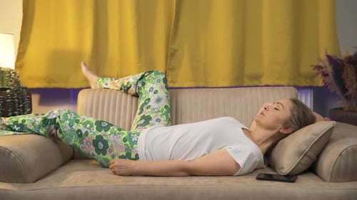 Woman Relaxing on Couch at Home, Sleeping