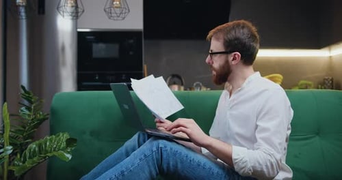Young Adult Working on Laptop at Home