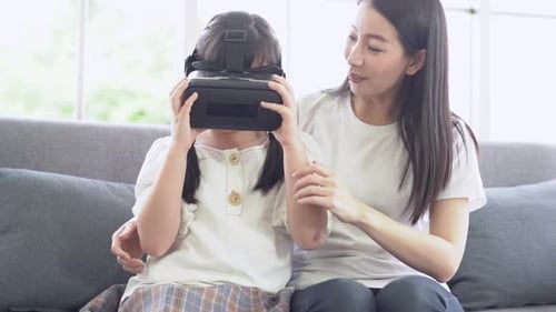 Child with VR Headset With Adult On Couch