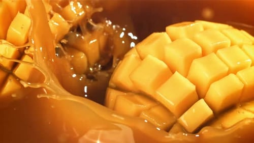 Half a Mango Falls Into the Juice with Splashes Filmed on a Highspeed Camera at 1000 Fps