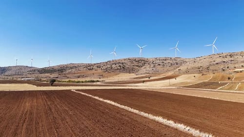 Wind Turbines on Hill above Farm Field