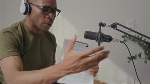 Man Explaining Music Notes in Front of Microphone