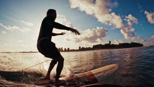 Man Surfs the Wave and Does Hand Five Trick By Walking to the Nose of the Board