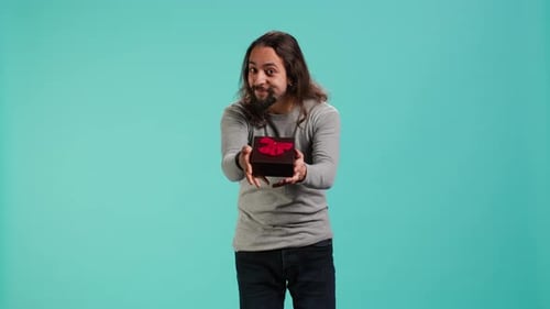 Portrait of Smiling Man Offering Gift for Birthday Celebration