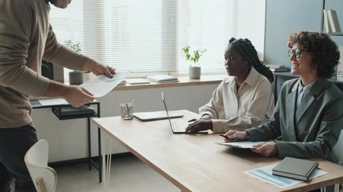 Mature Caucasian Man Entering Office To Have Job Interview With Female HR