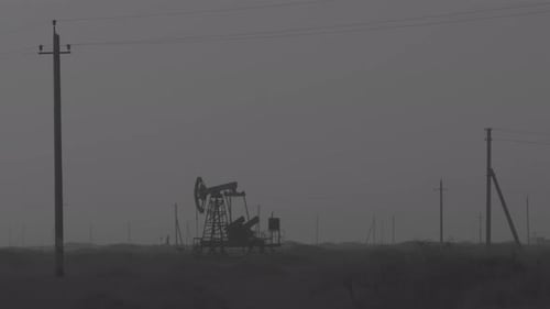 Oil Industry Pumping Petroleum Rig in Desert Pump Jack Extracting Crude Oil From a Oil Well Fossil