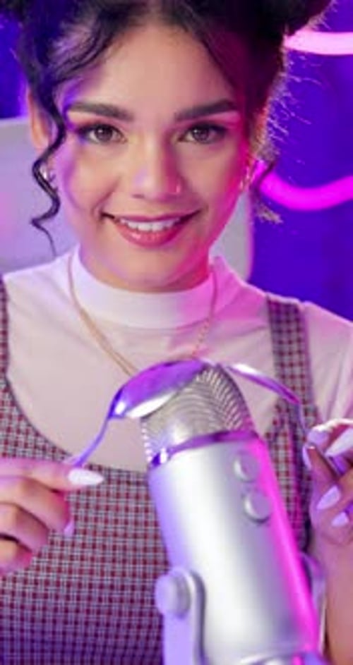 Podcast, woman and happy with spoons microphone on neon background for live streaming