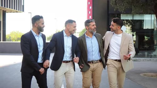 Businessmen Laughing Together on City Sidewalk
