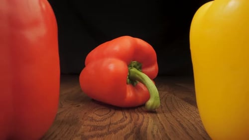 Red and Yellow Peppers on a Wooden Surface