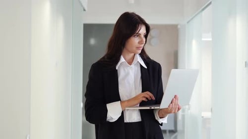 Pensive Beautiful Businesswoman Office Worker Entrepreneur Works on Laptop