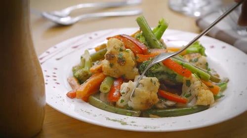 antipasto plate with vegetables, green beans, cauliflower, paprika, olive oil in slow motion