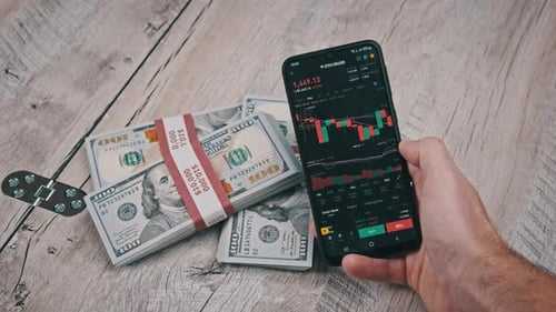 Trader Analyzes Ethereum Cryptocurrency Prices on Smartphone Above Dollars