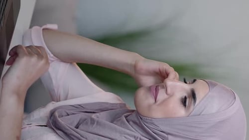 Woman Wearing Hijab with Hand Up to Face