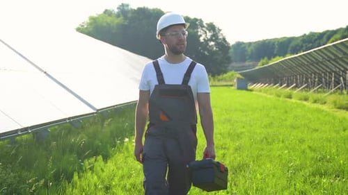 Solar Farm with Engineer Walk to Check the Operation of the System Alternative Energy to Conserve