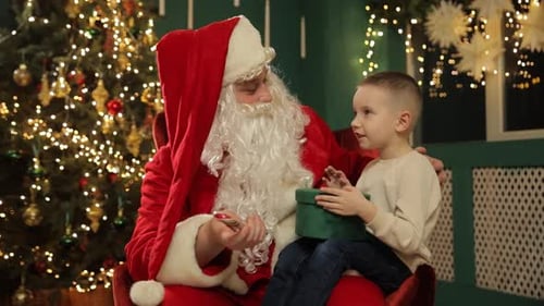 Santa Claus with Boy Offering a Candy Cane