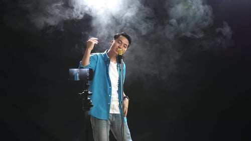 Singer Performs with Microphone on Stage with Smoke