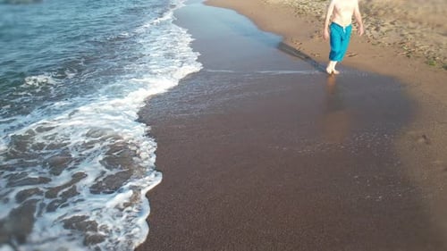 Man Walking on Beach