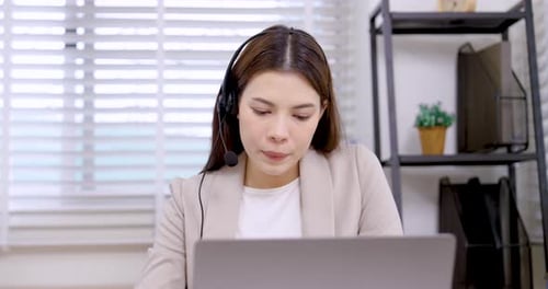 Woman Attending Video Conference Call in Home Office
