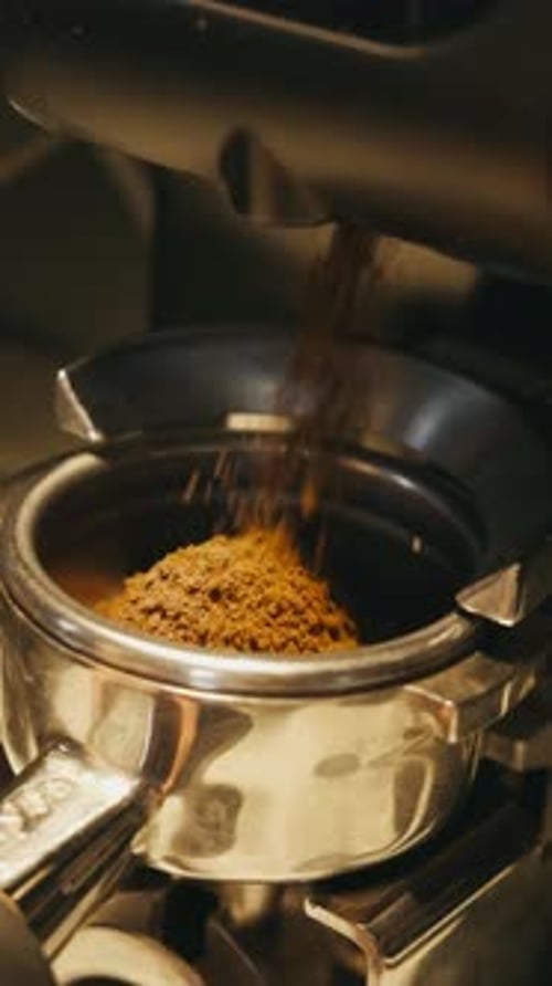 Coffee Grounds Falling into Portafilter Close Up