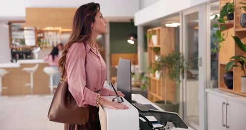 Frustrated, woman and reception with bell at hotel for assistance, delay and waiting to check in