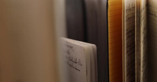 Handheld moving close-up shot of old notebooks