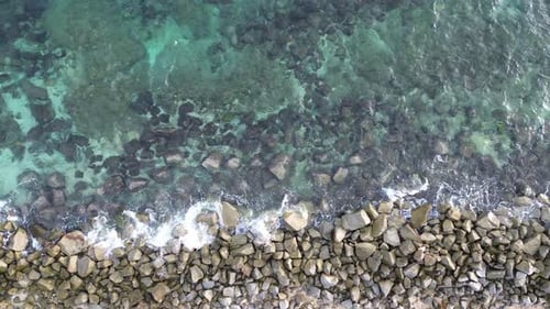 aerial view of pebble beach with blue sea