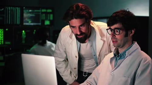 Two Scientific Male Doctors with Lab Coat Doing a Medicine Biology or Pharmacy Investigation and