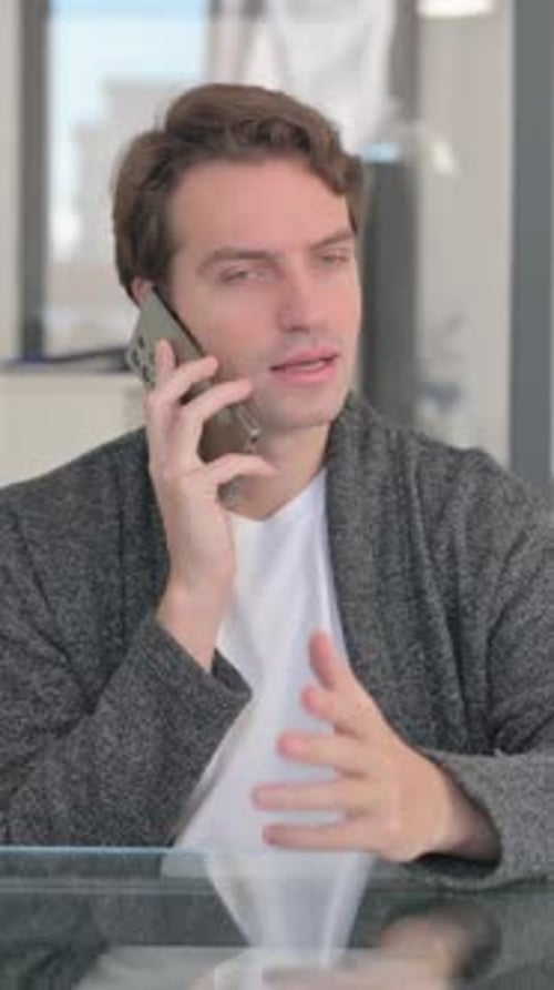 Man Talking on Mobile Phone at Home Indoor
