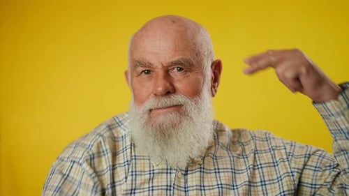 Senior Man with Beard Making Hand Gestures