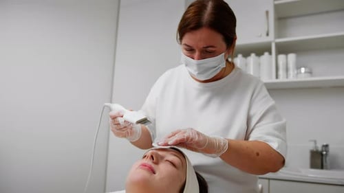 Woman Receiving a Facial in a Clinic