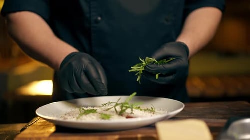 Close Up in Restaurant in a Rib Bar in the Central Hall a Chef in Black Gloves Puts a Salad