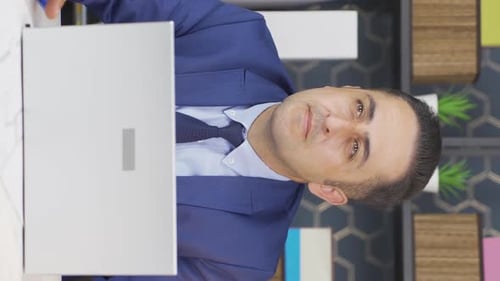 Adult Smiling in Blue Suit at Desk