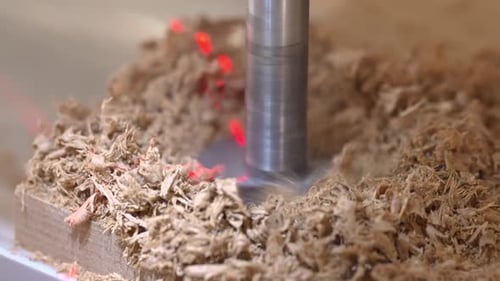 Close Up Drilling into Wood with Drill Press and Sawdust
