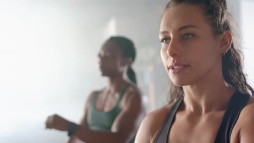 Stretching arms, women warming up in gym before fitness workout session