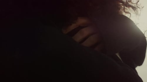 Romantic couple embracing with sun flare