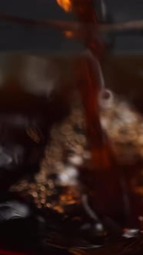 Dark Brown Liquid Pouring into Glass Close-Up