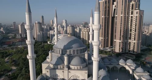 Aerial video flies forward above, crossing between two minarets on a mosque in Istanbul
