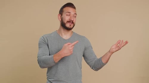 Lebanese Man Showing Thumbs Up and Pointing Empty Blank Place Advertising Area for Commercial Text