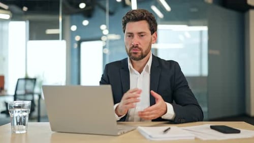 Man Talking During Video Conference Call at Office